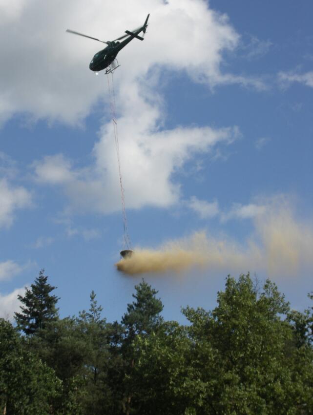 Helikopter bei der Ausbringung des Kalkmaterials