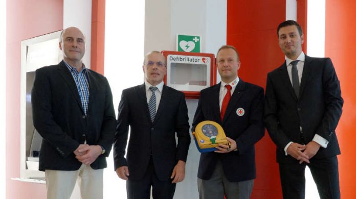 Vorstellung des AED in der Sparkassenfiliale: (v.l.) Beigeordneter Georg Krist, Matthäus Seckinger, Michael Römer und Marcel Kaiser
