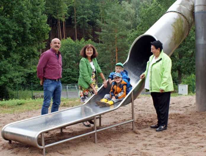 Freuen sich über die Inbetriebnahme der sanierten Turmrutsche:  Landrätin Theresia Riedmaier (Mitte), Geschäftsführerin Marianne Geppert (rechts) und Geschäftsführer Michael Müller (links) mit Julius und Lukas. (Foto: Kreisverwaltung Südliche Weinstraße)